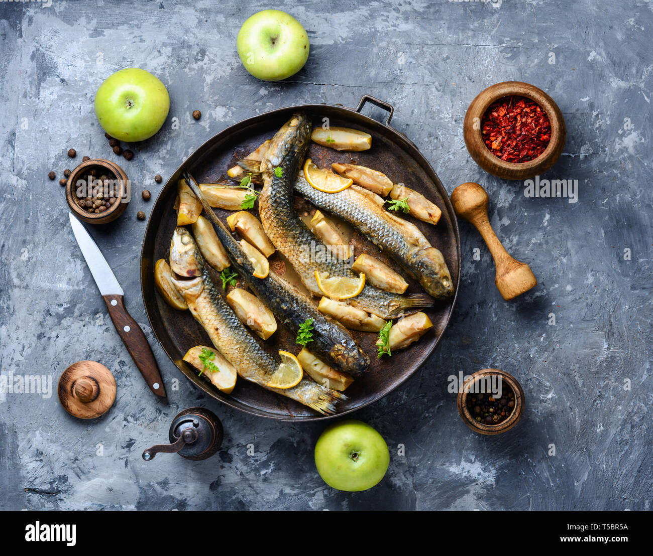 Baked fish in apples, lemon and spices.Grilled pelengas Stock Photo Alamy