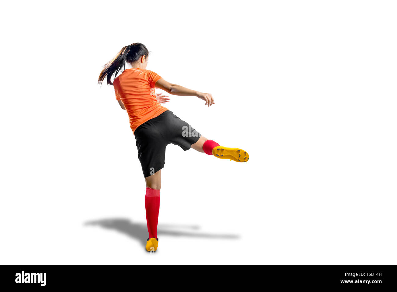 Woman kicking ball hi-res stock photography and images - Alamy