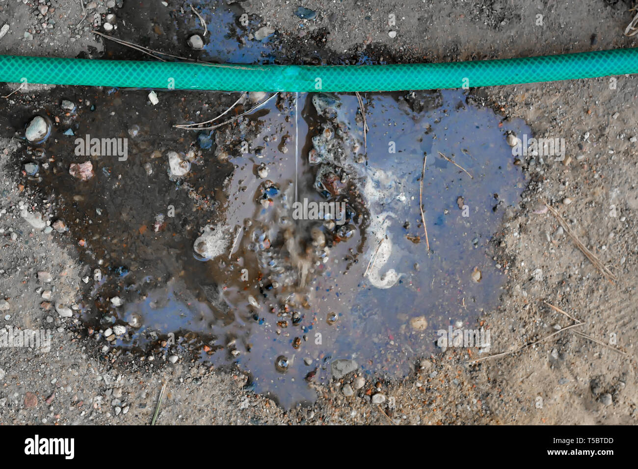 crack in the watering hose. Damaged hose Stock Photo Alamy