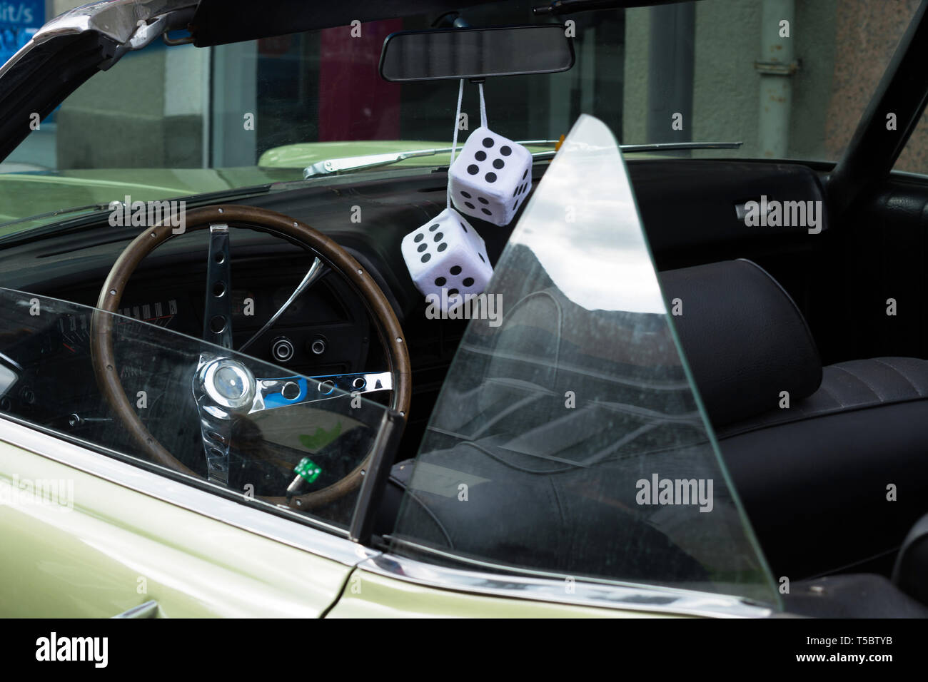 Fuzzy Dice on the rearview mirror of a vintage American car Stock Photo