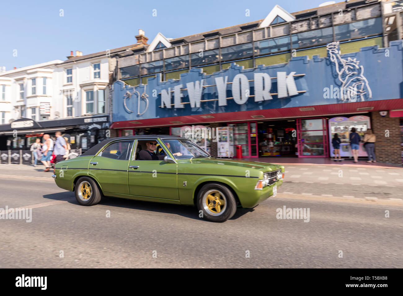 Ford Cortina Mark III classic car at Southend on Sea, Essex, seafront on a sunny day. Driving on Marine Parade past New York amusements Stock Photo