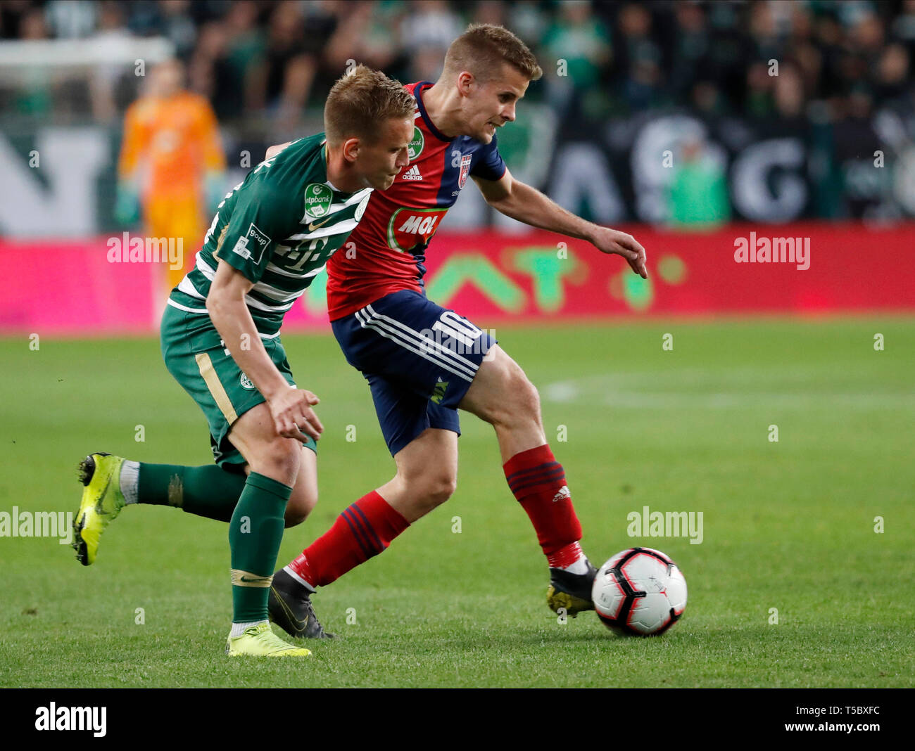 Kenneth Otigba of Ferencvarosi TC tackles Marko Futacs of MOL