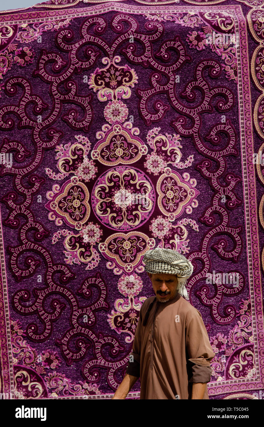 A brightly coloured carpet for sale in the Souk at Ibra, Oman Stock