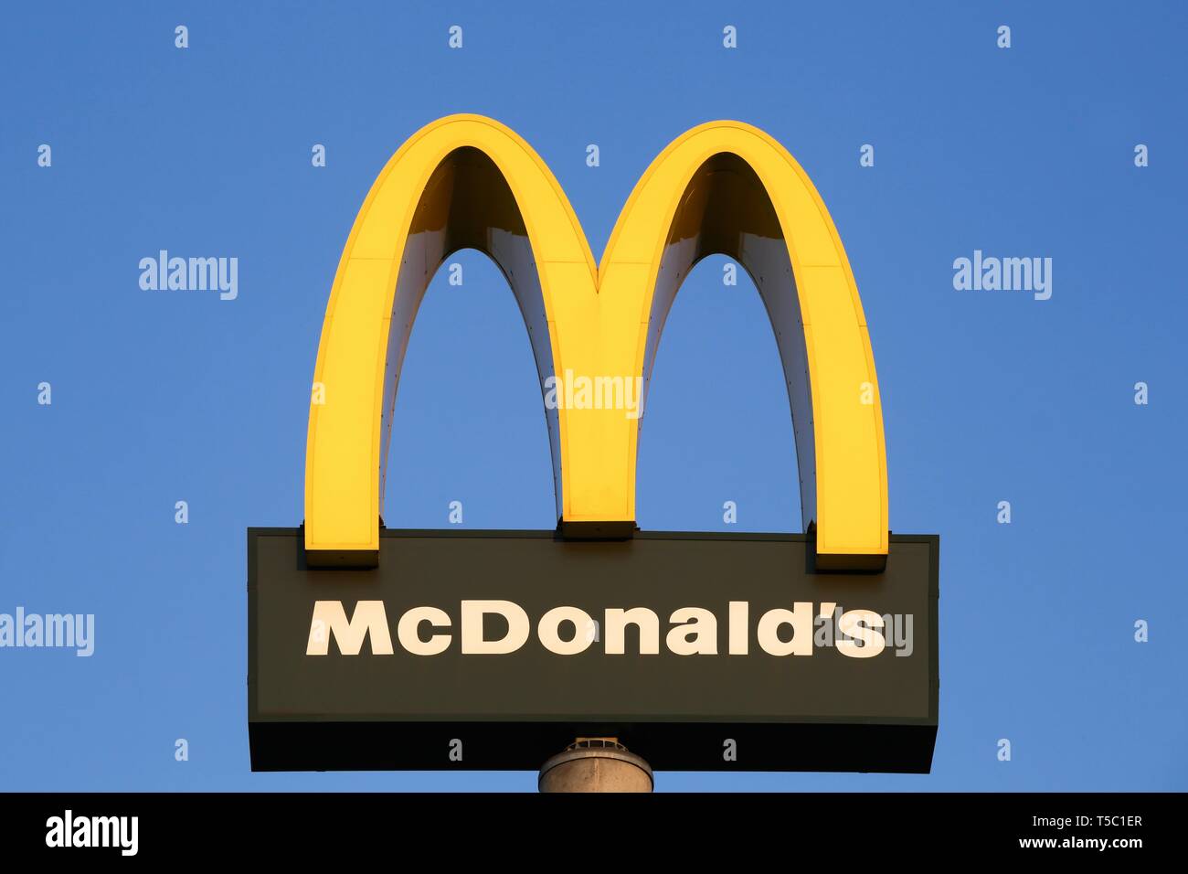 Datgen, Germany - July 22, 2018:  Mc Donald's logo on a pole. McDonald's is the world's largest chain of hamburger fast food restaurants Stock Photo