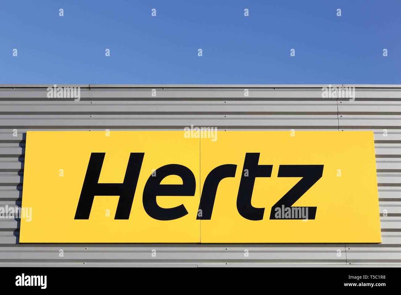 Bourg, France - April 5, 2019: Hertz logo on a wall. Hertz is an American car rental company with international locations in 145 countries worldwide Stock Photo