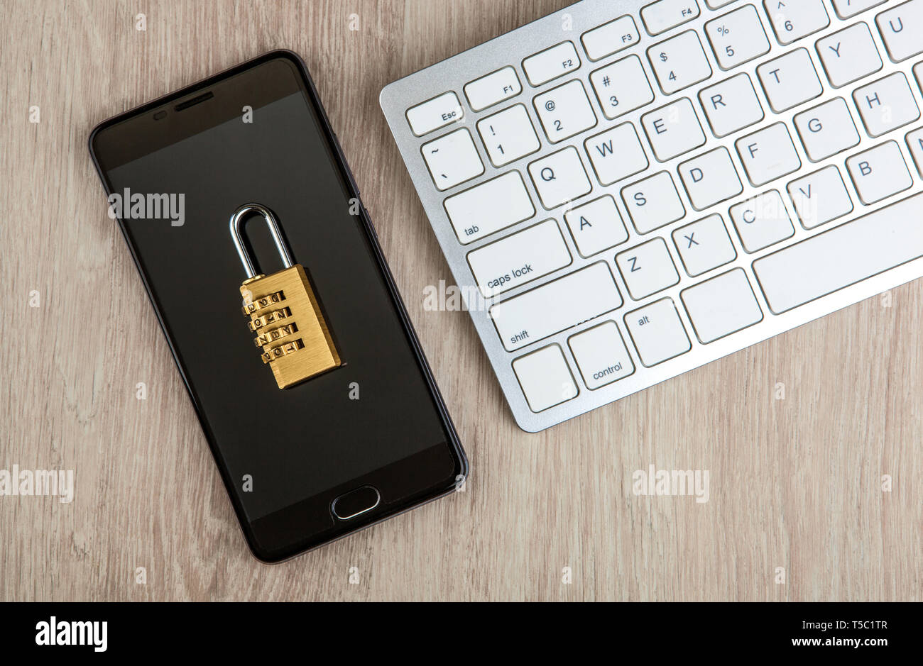 padlock on a smartphone with a computer keyboard top view Stock Photo