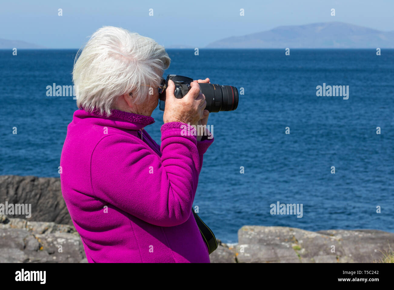 Senior woman taking photograph with DSLR Stock Photo