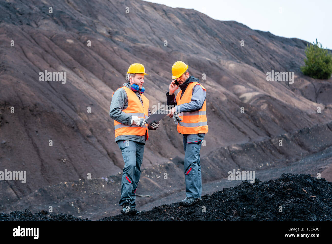 Workers in open-cast mining operation pit Stock Photo