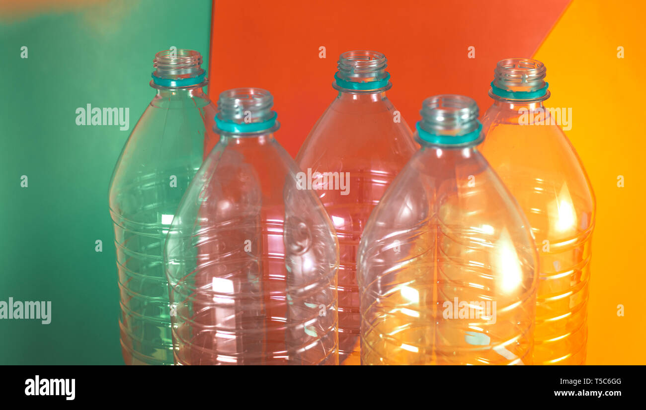 A pack of 5 empty and recyclable water bottles, with no caps, on a