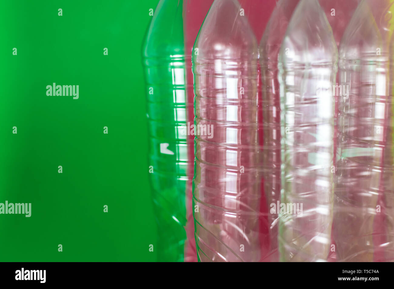 A pack of empty and recyclable plastic water bottles, on a colored