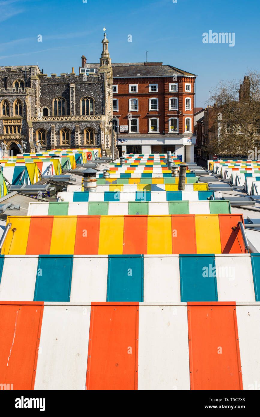 Colourful striped roofs of Norwich city market with the Guildhall to the rear. Norfolk, East Anglia, England, UK. Stock Photo