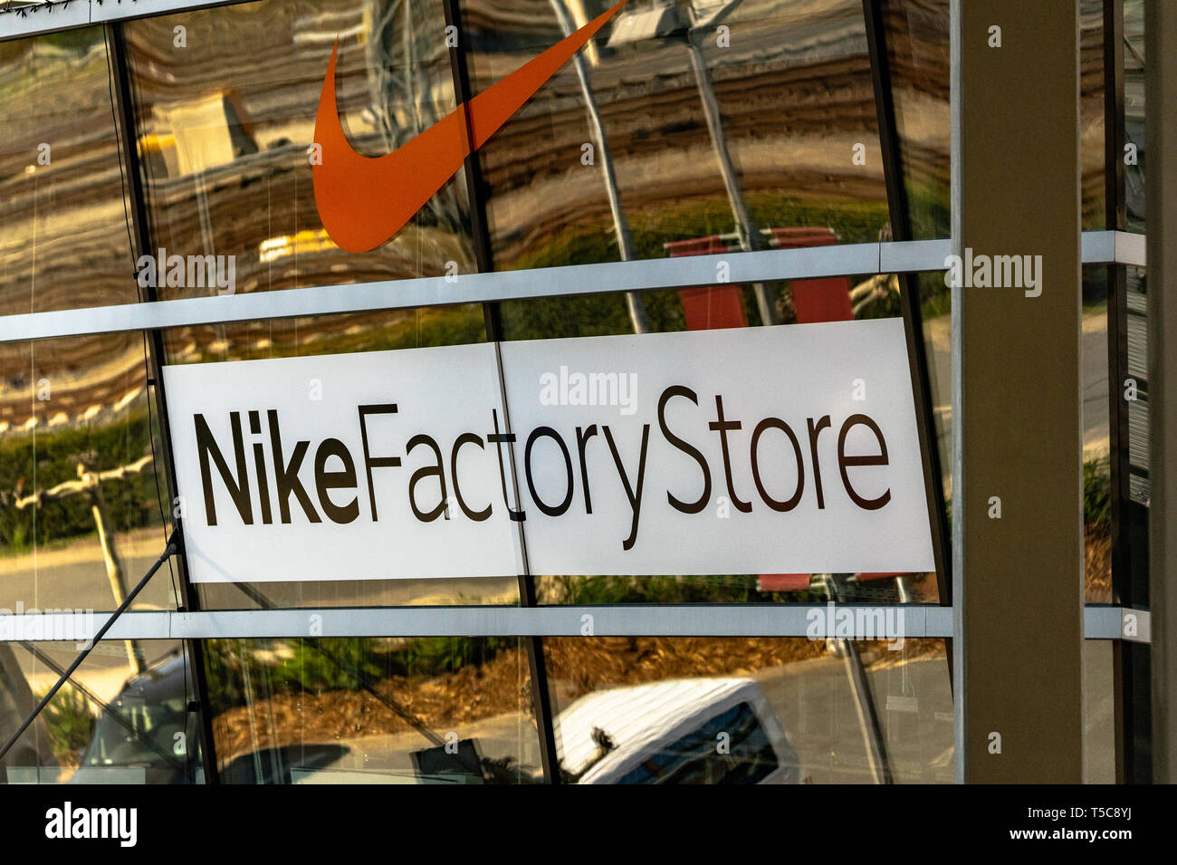 Factory stor of the company Nike in the designer Outlet in Wolfsborg, with big windows, the Nike logo and a lettering, Wolfsburg, Germany, April 20.,  Stock Photo