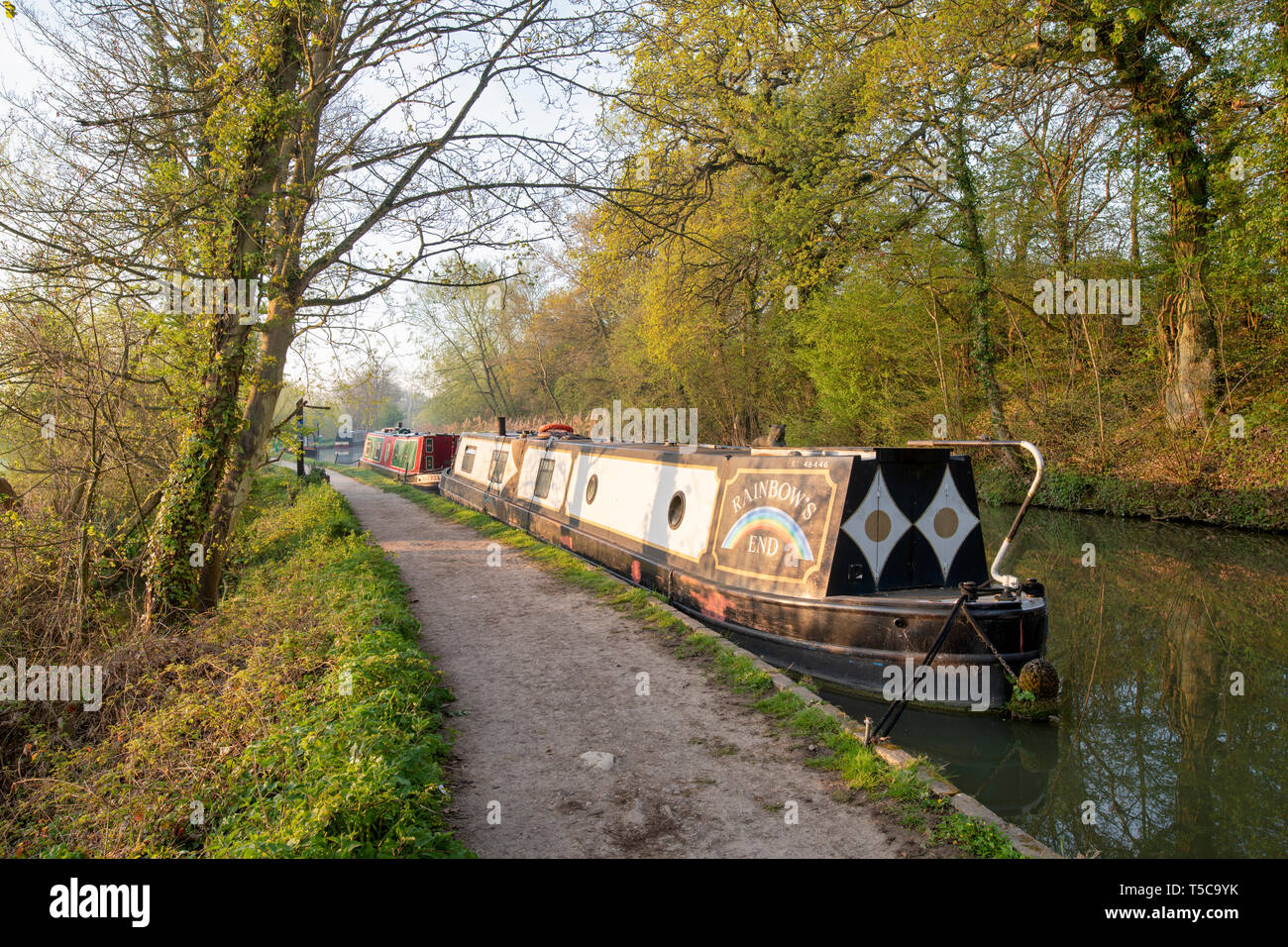Canal boats on the oxford canal in the early morning spring sunlight. Shipton on Cherwell, Oxfordshire, England Stock Photo