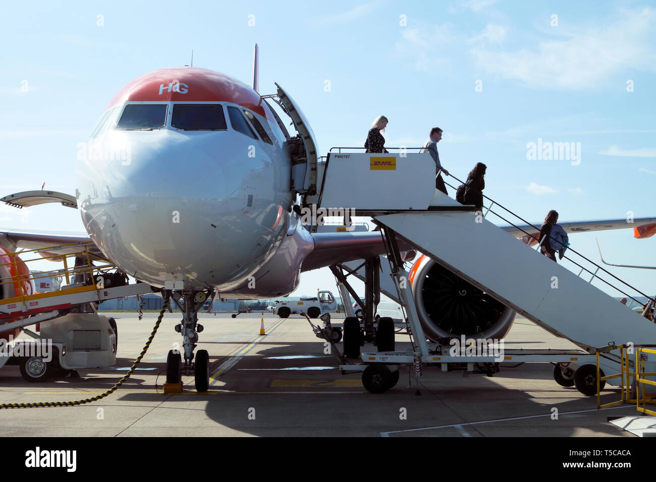 Front side view of passengers getting off leaving an Easyjet aircraft plane on the tarmac at Bristol Airport England UK Great Britain  KATHY DEWITT Stock Photo