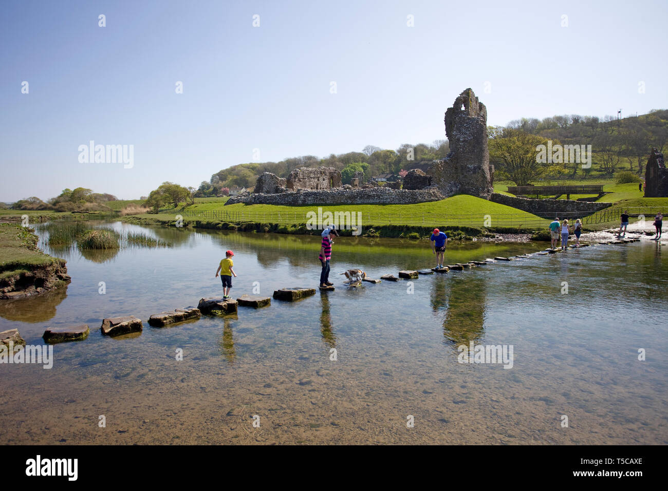 Walking across the steppingstones by ogmore castle. Vale of glamorgan. south wales Stock Photo