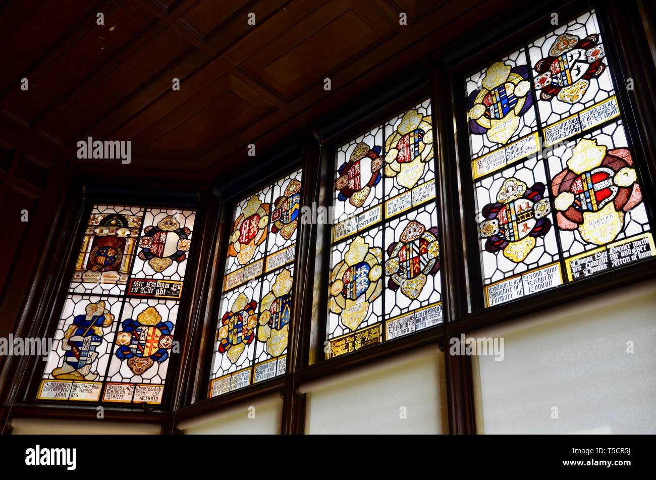 Heraldic stained glass in The Great Hall at Charlecote House, Warwickshire, England, UK Stock Photo