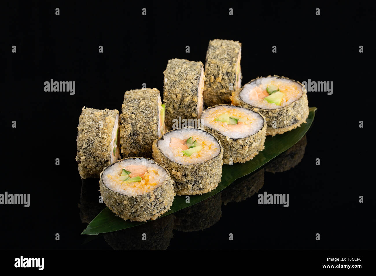 Sake Maki Sushi - Roll tempura with Fresh Salmon, avocado and Cucumber on  black background Stock Photo - Alamy