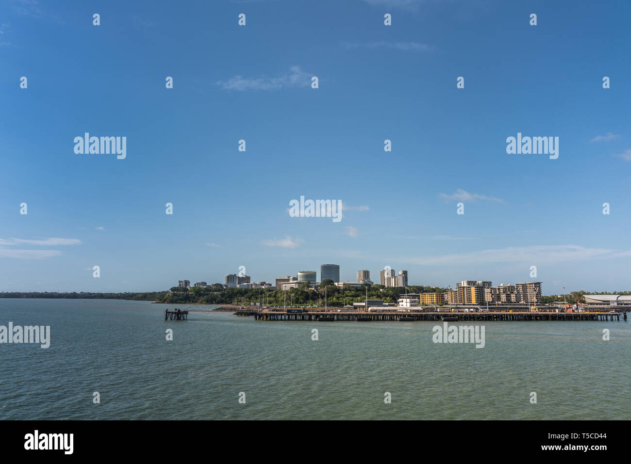 Darwin Australia - February 22, 2019: western side of Darwin skyline seen from south upon harbour bay water under blue sky. Convention center to the l Stock Photo