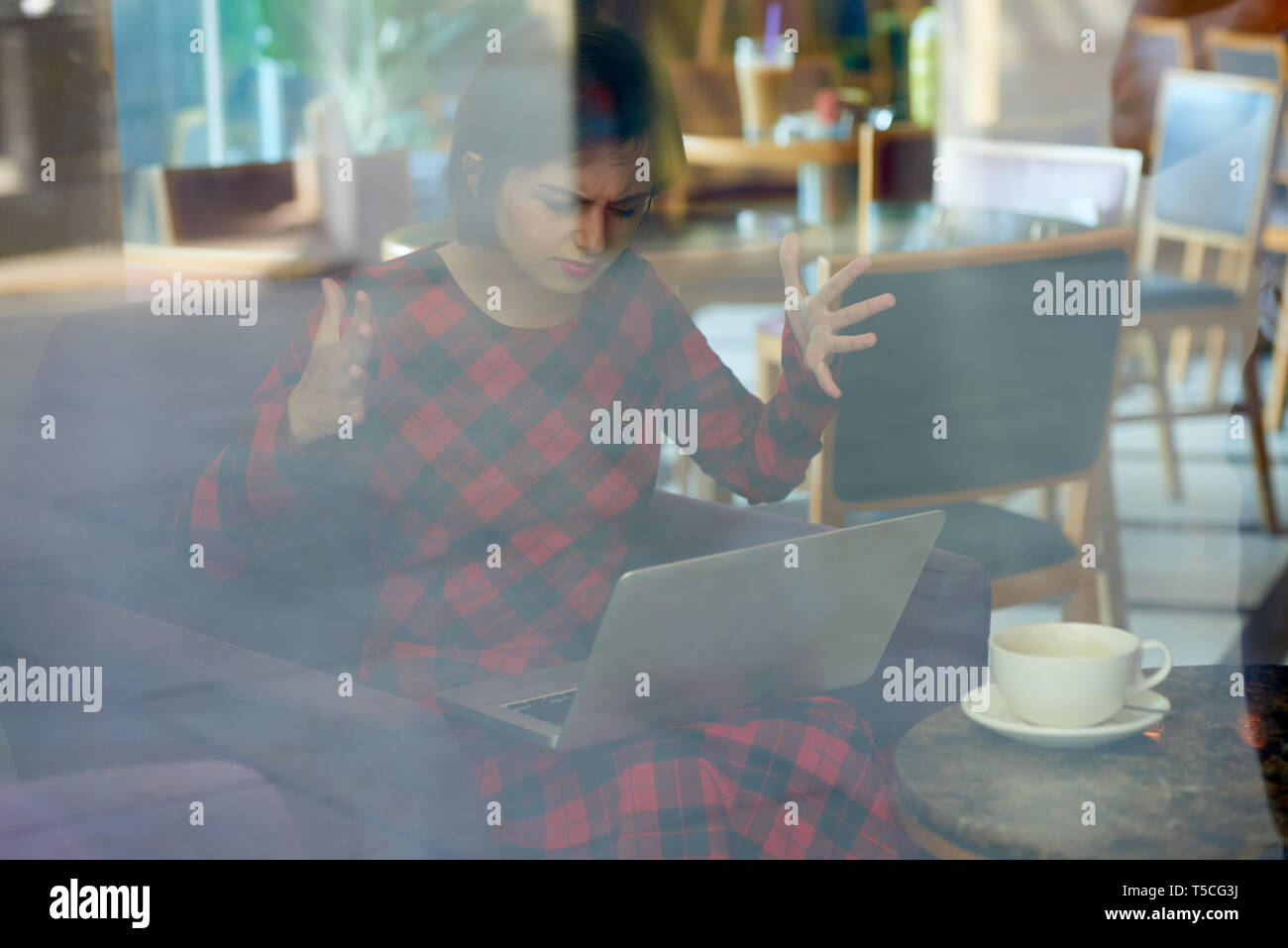 Desperate woman with broken laptop Stock Photo
