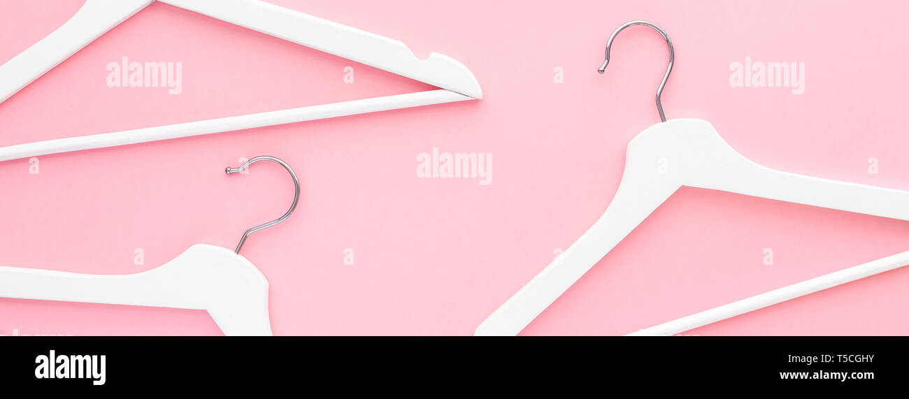 Creative top view flat lay white wooden hangers pastel millennial pink ...