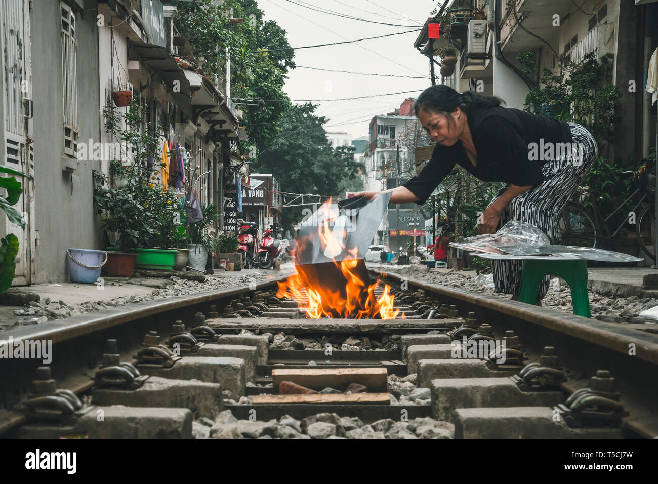 Hanoi. Vietnam. 13 January 2019 Woman burns votive offerings. Many
