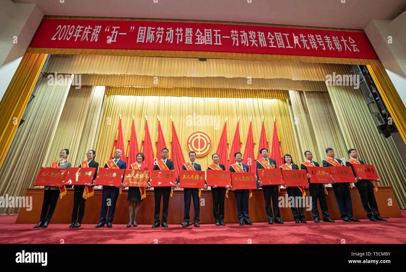 Beijing, China. 23rd Apr, 2019. Representatives pose for a group photo at a conference held to highlight the contribution of 'model workers' and groups in Beijing, capital of China, April 23, 2019. China on Tuesday held a conference here to highlight the contribution of 'model workers' and groups ahead of the International Labor Day, which falls on May 1. A total of 695 individuals and more than 800 groups were honored at the event. Credit: Cai Yang/Xinhua/Alamy Live News Stock Photo