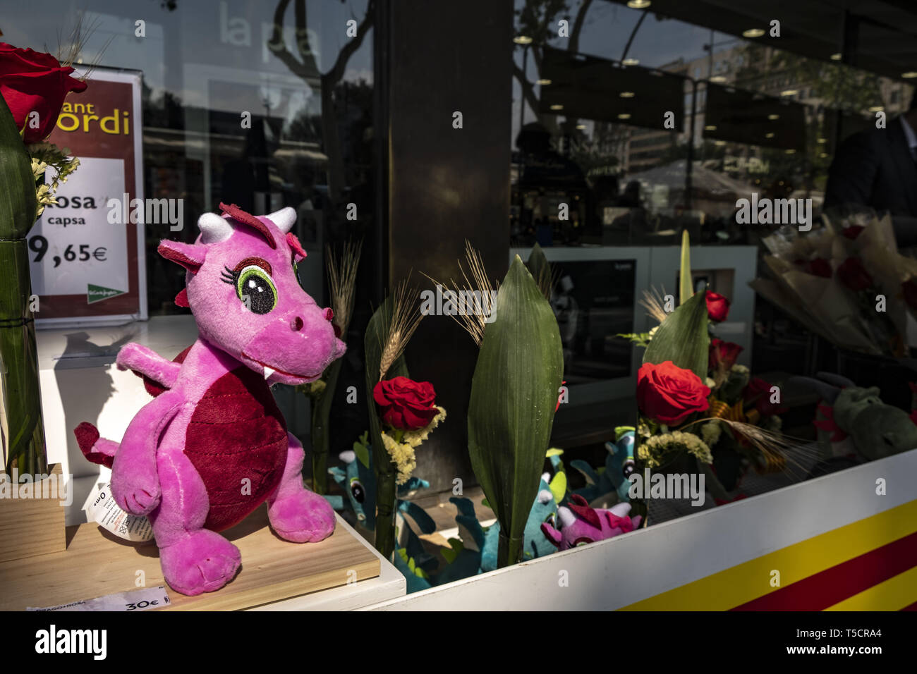 Barcelona, Catalonia, Spain. 23rd Apr, 2019. Stuffed animals representing  the traditional dead dragon by the Sant Jordi are seen next to red roses  during the Sant Jordi day celebration.The festivity of Sant
