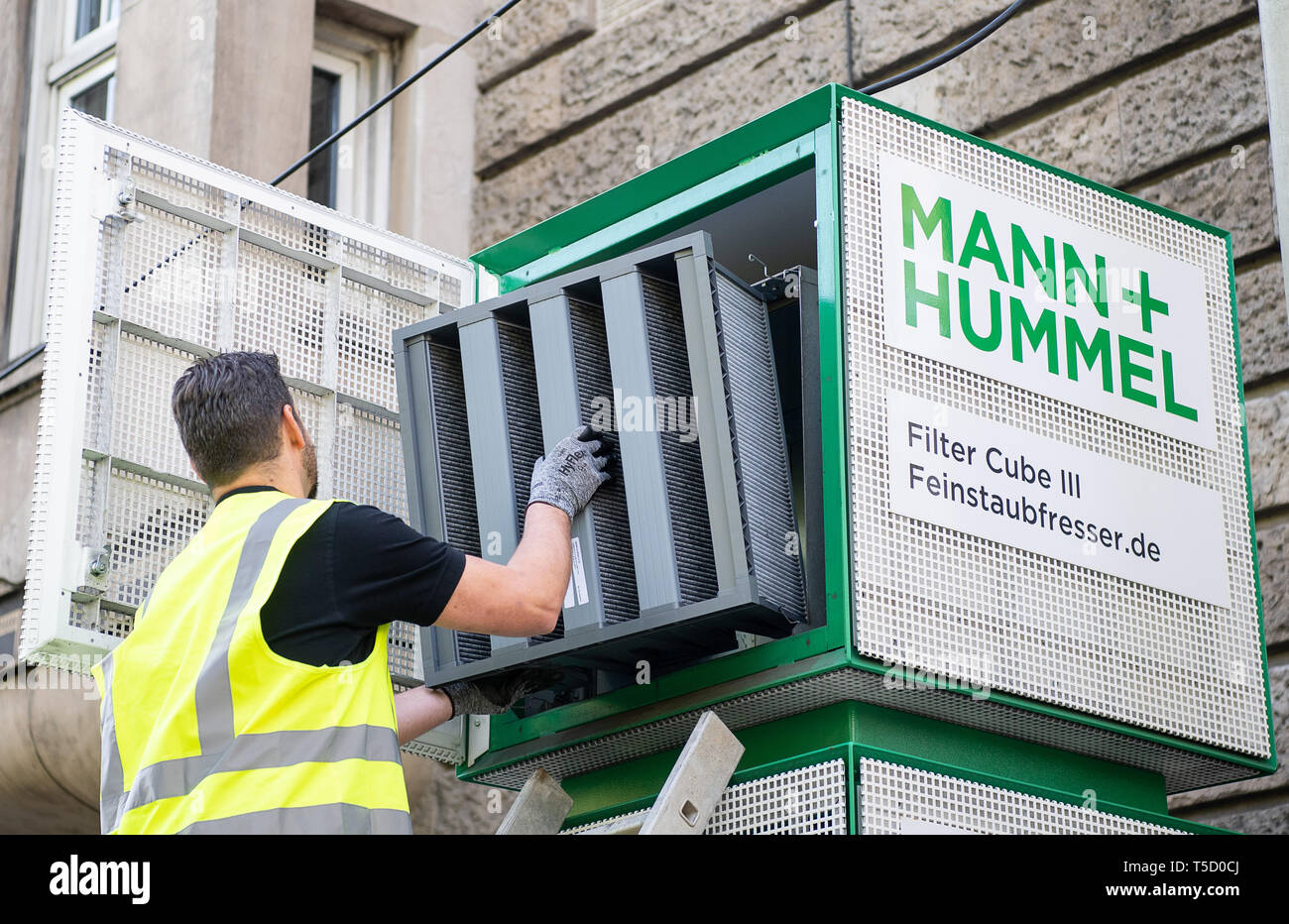 Stuttgart, Germany. 24th Apr, 2019. An employee of Mann Hummel retrofits  filter columns at the Neckartor with filters that can filter both fine dust  and nitrogen dioxide. Credit: Sebastian Gollnow/dpa/Alamy Live News