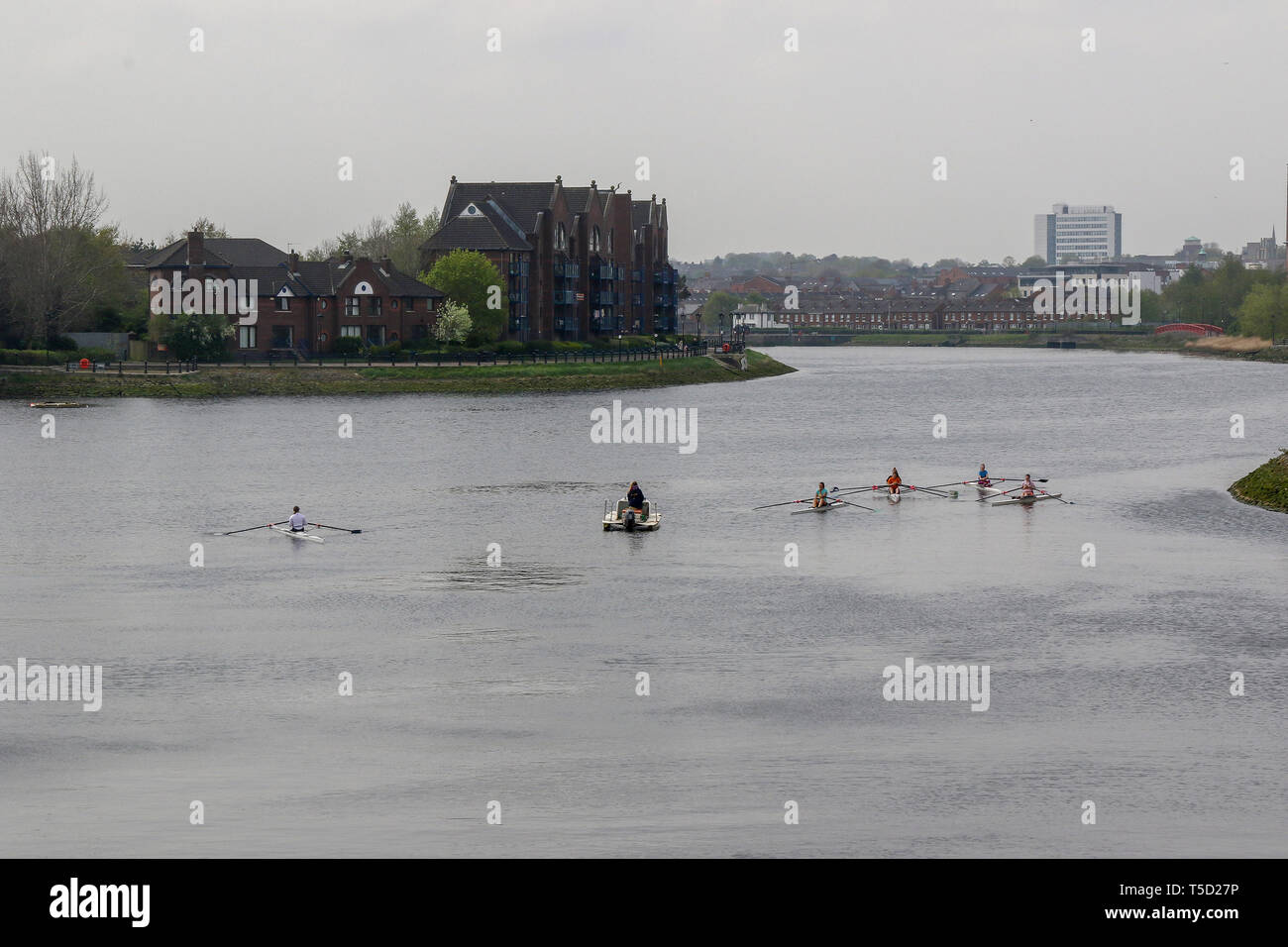 Belfast, Northern Ireland, UK. 24 April 2019.  UK weather: a hazy but mild day in Belfast with overcast skies. Rowers on the River Lagan. Credit: CAZIMB/Alamy Live News. Stock Photo