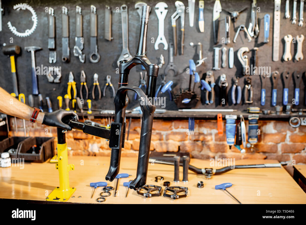 Bicycle fork during the repairing process hanging on a stand in the