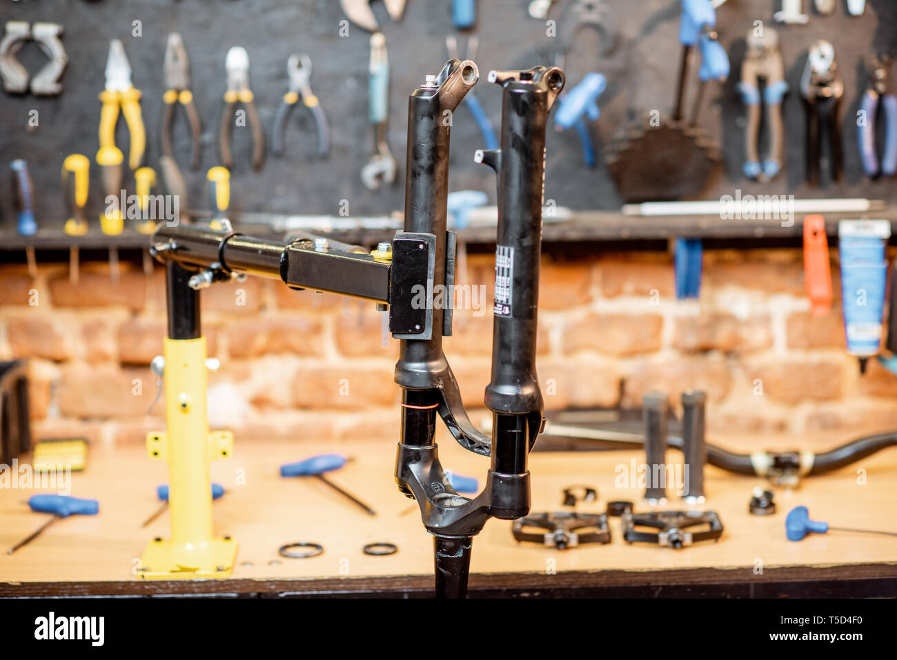 Bicycle fork during the repairing process hanging on a stand in the
