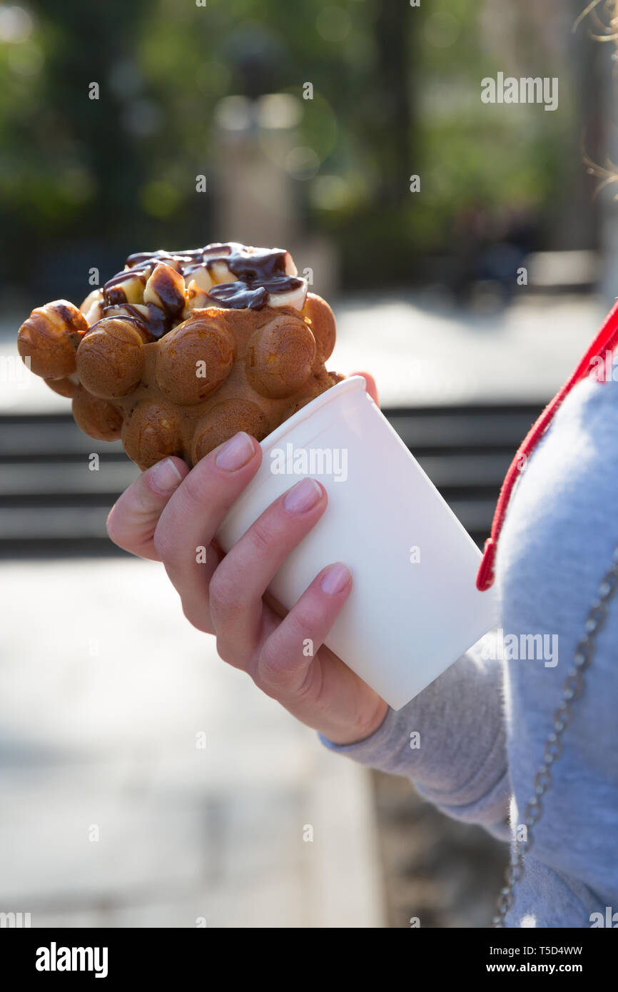 Hand with bubble waffle ice cream photo for graphic and web design, for website or mobile app