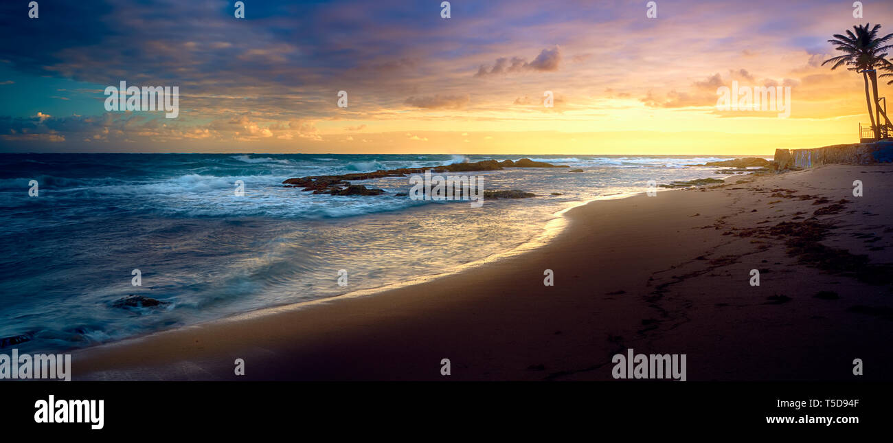 Beautiful sunset clouds and palm trees on Puerto Rico Beach Stock Photo