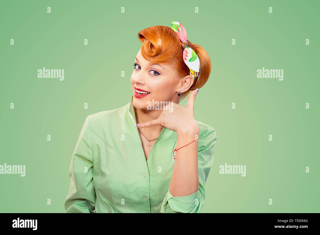 Closeup redhead young woman pretty pinup girl retro vintage 50's style in  button shirt making showing call me sign gesture asking to contact her  looki Stock Photo - Alamy