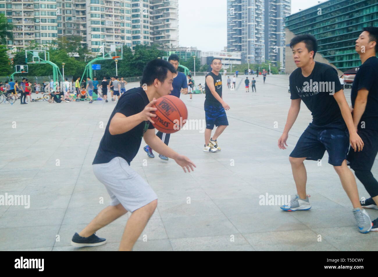 Shenzhen, China: People play basketball on weekends Stock Photo