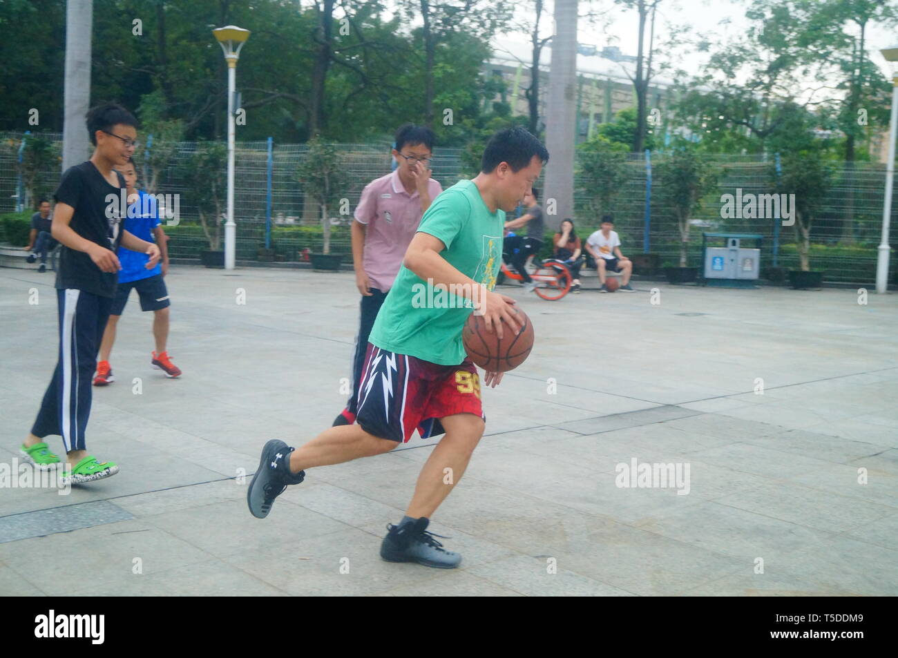 Shenzhen, China: People play basketball on weekends Stock Photo