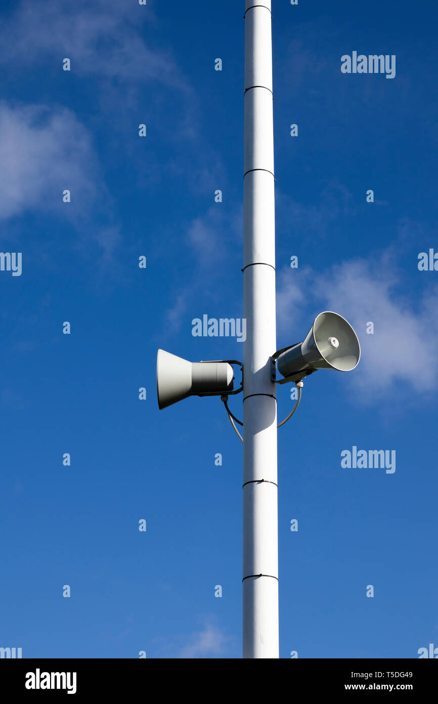 PA public address system speakers fixed to timber telegraph pole Stock