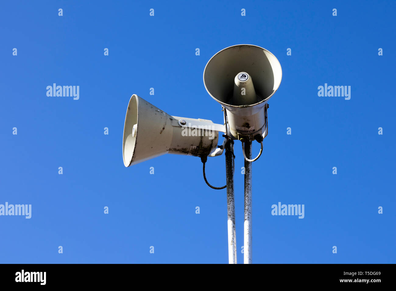 PA public address system speakers fixed to timber telegraph pole Stock