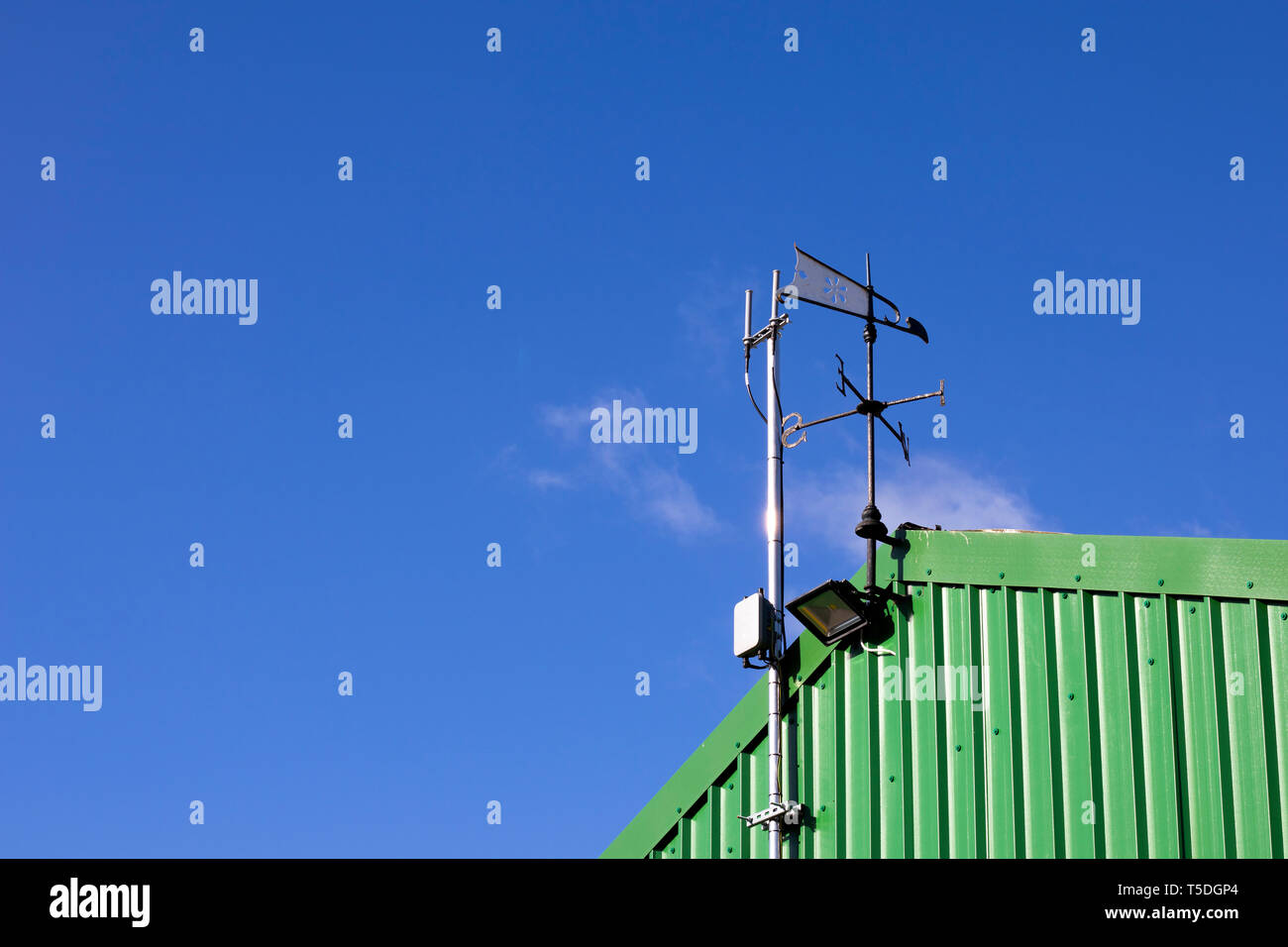Metal weather vane fixed to top of building to show wind direction with
