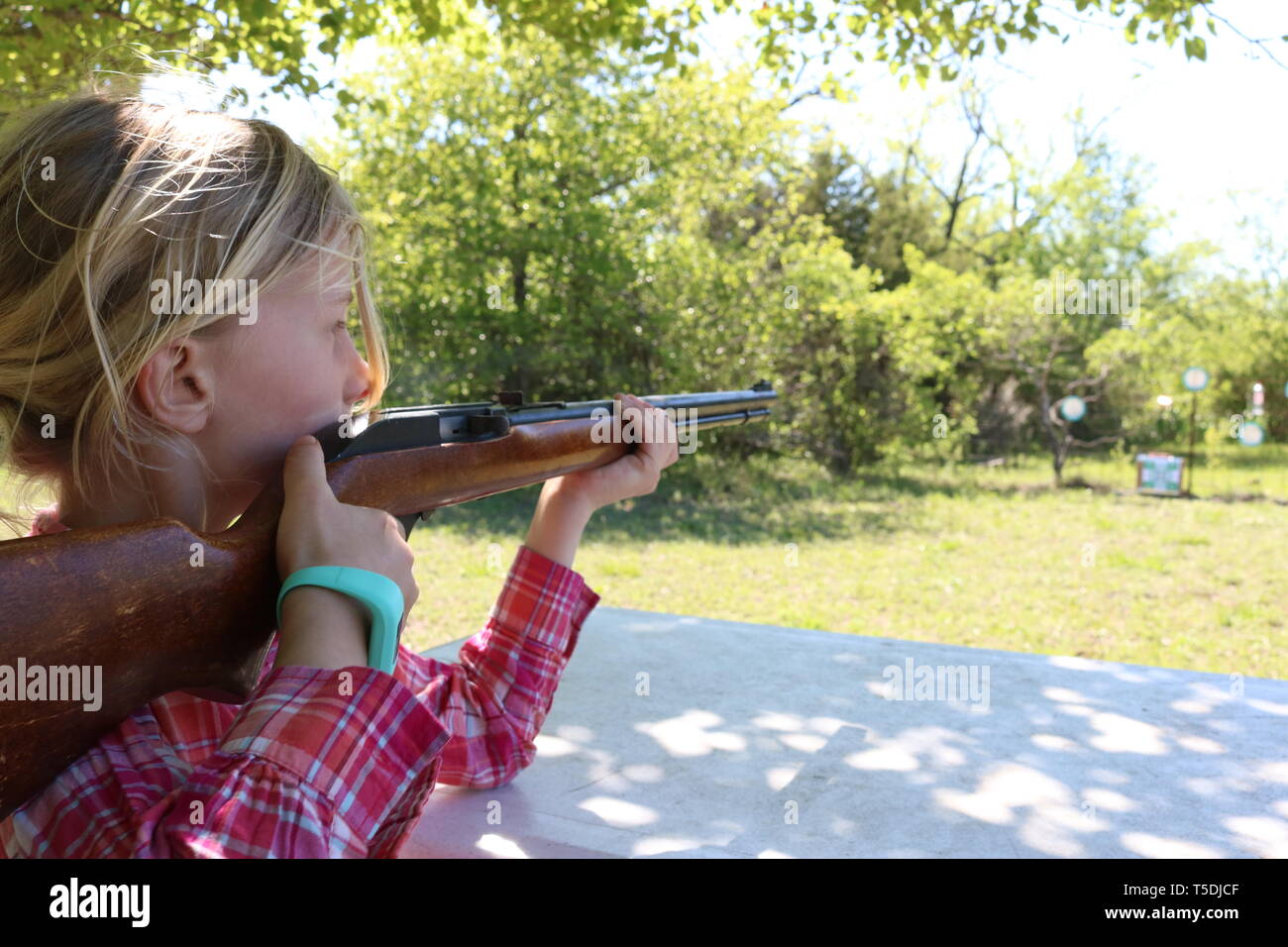 Girl aiming to shoot at target Stock Photo Alamy