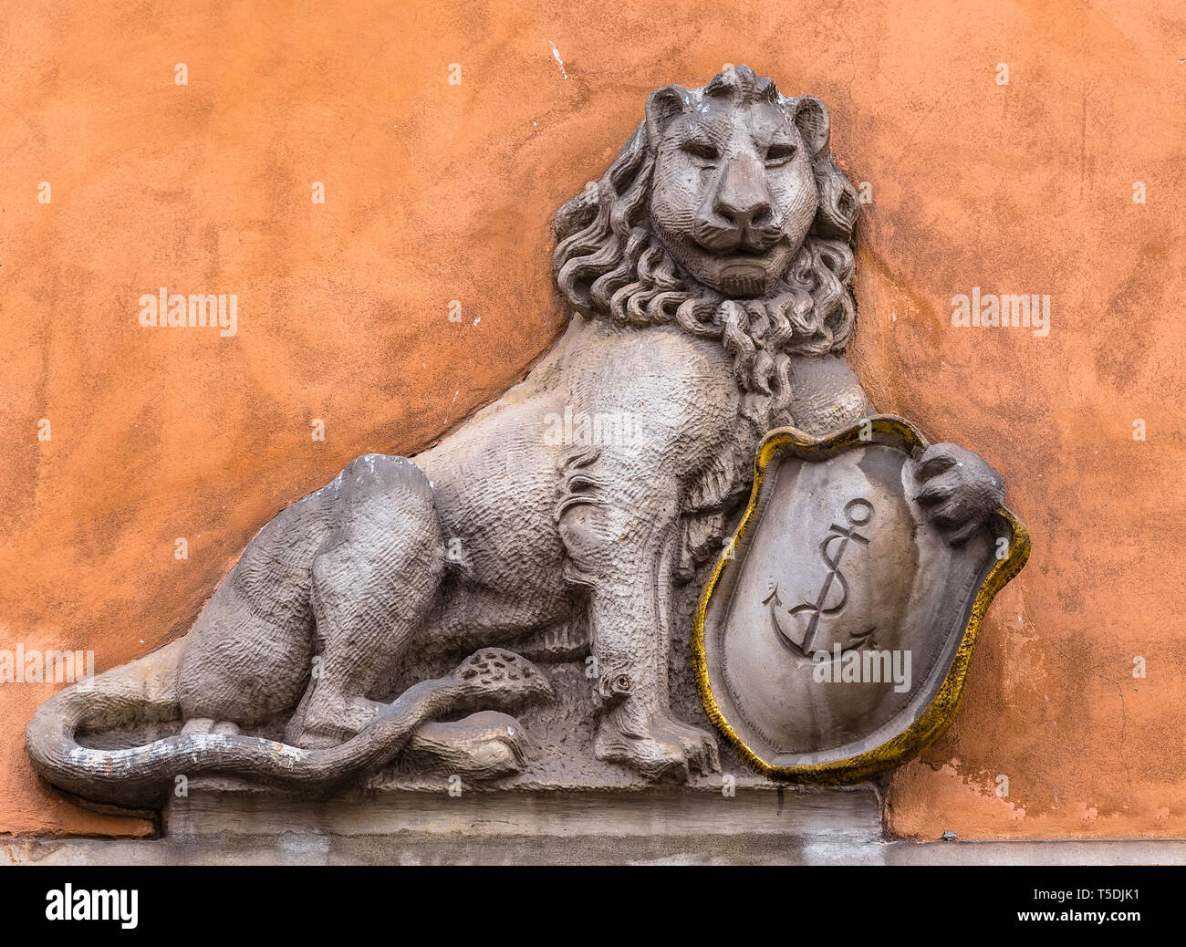 Bas-relief of a lion with a shield on the wall Stock Photo