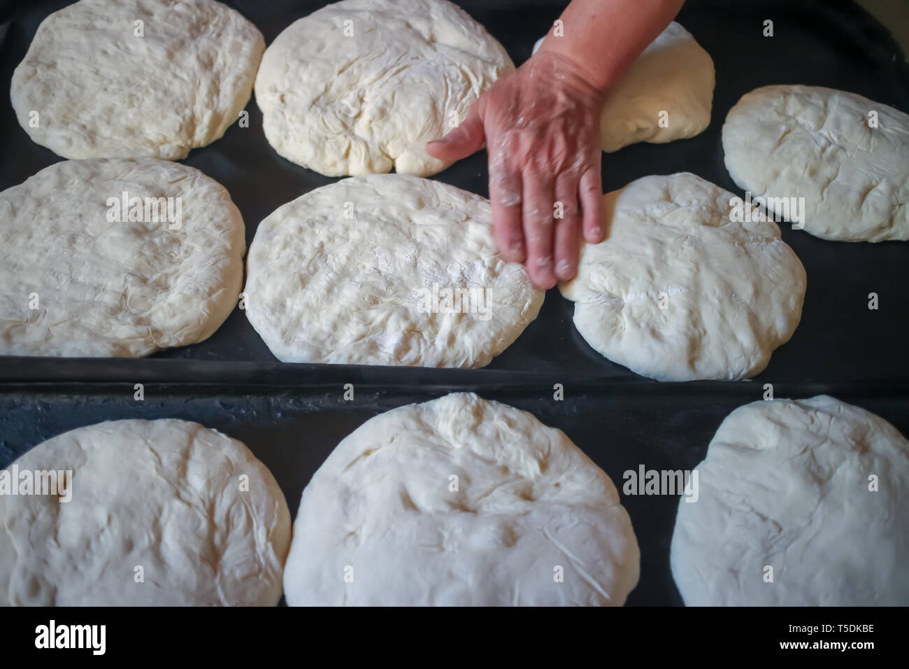 traditional village bread making and dough being placed on the baking