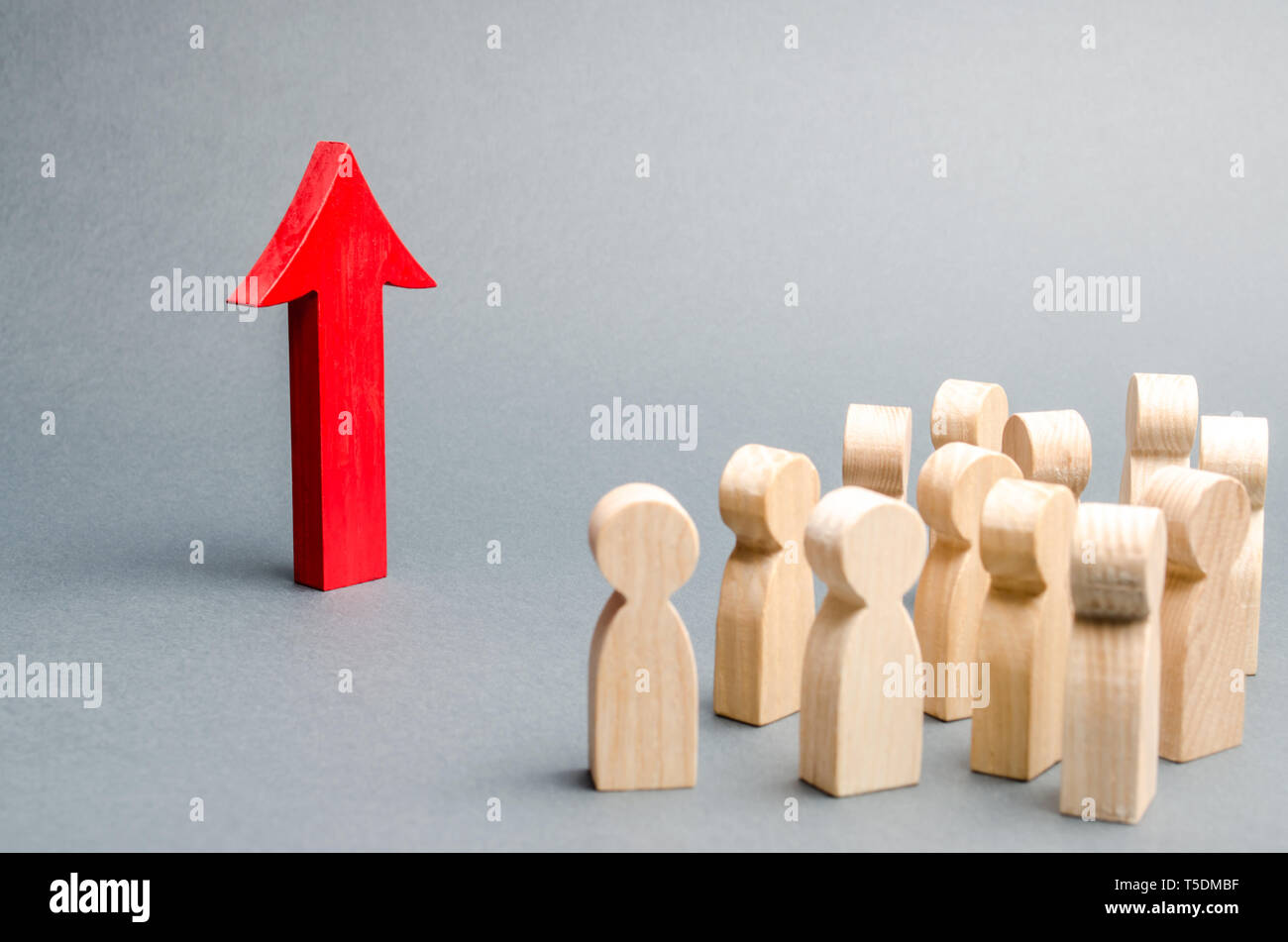 A crowd of people looking at the red arrow up. growth and development ...