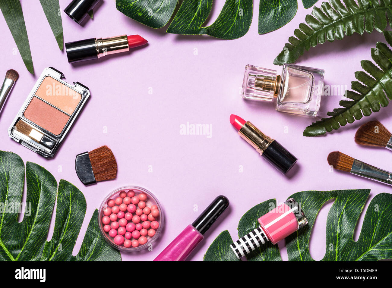 Makeup professional cosmetics on purple background.  Stock Photo