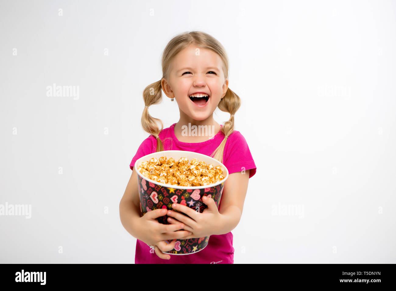 baby girl with popcorn on white isolate background.Little cute baby