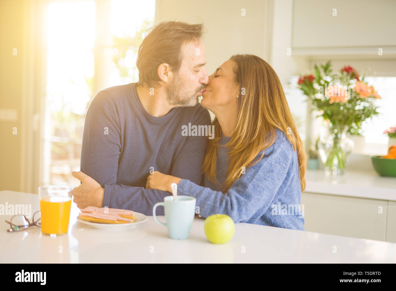 Beautiful Romantic Middle Age Couple Kissing Having Healthy Breaskfast In The Morning At Home Stock Photo Alamy