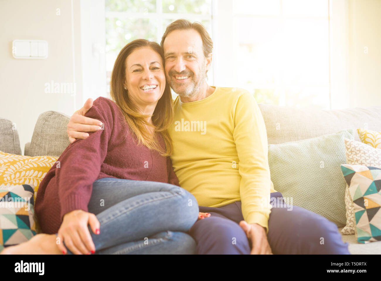 Middle age romantic couple sitting on the sofa at home Stock Photo - Alamy