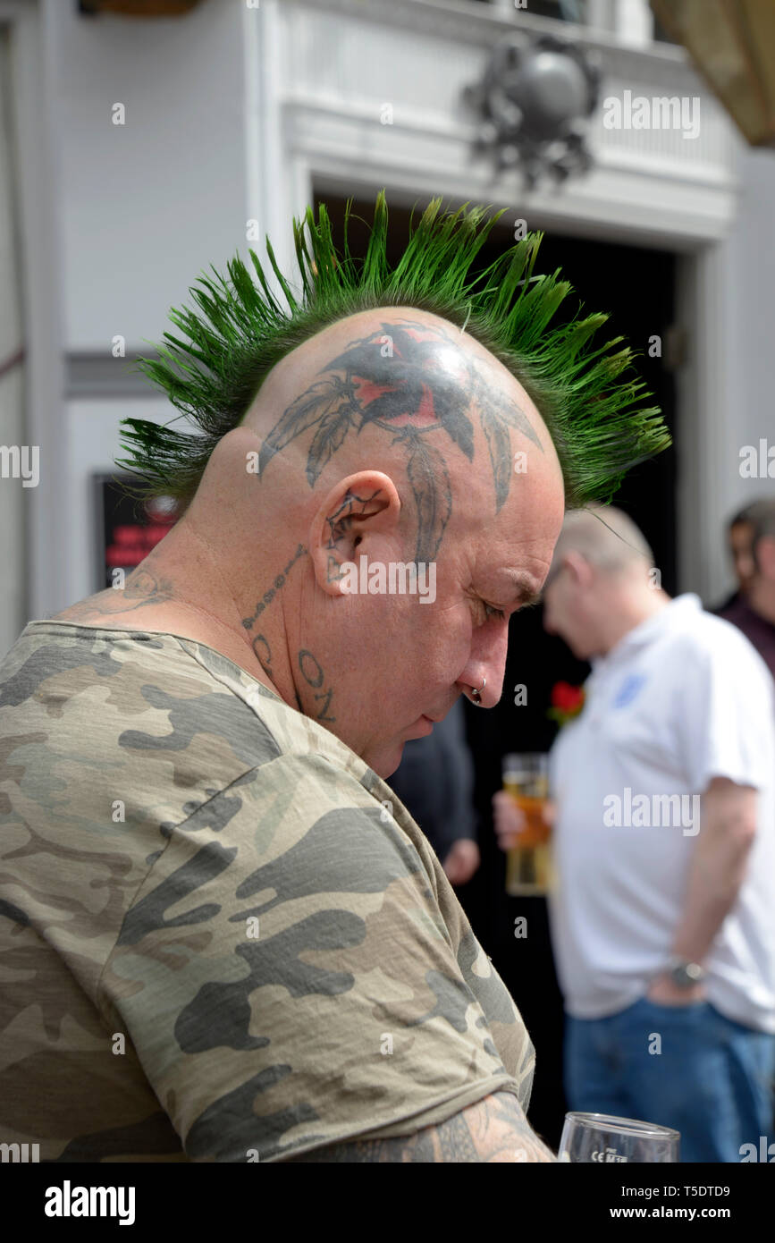 Man with tattooed head, & mohican green hair. Stock Photo