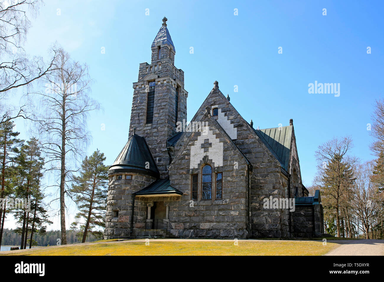 Karuna Church and bell tower in Karuna, Sauvo, South of Finland in spring.The church was built in 1908-10 in the style of Finnish National Romanticism Stock Photo