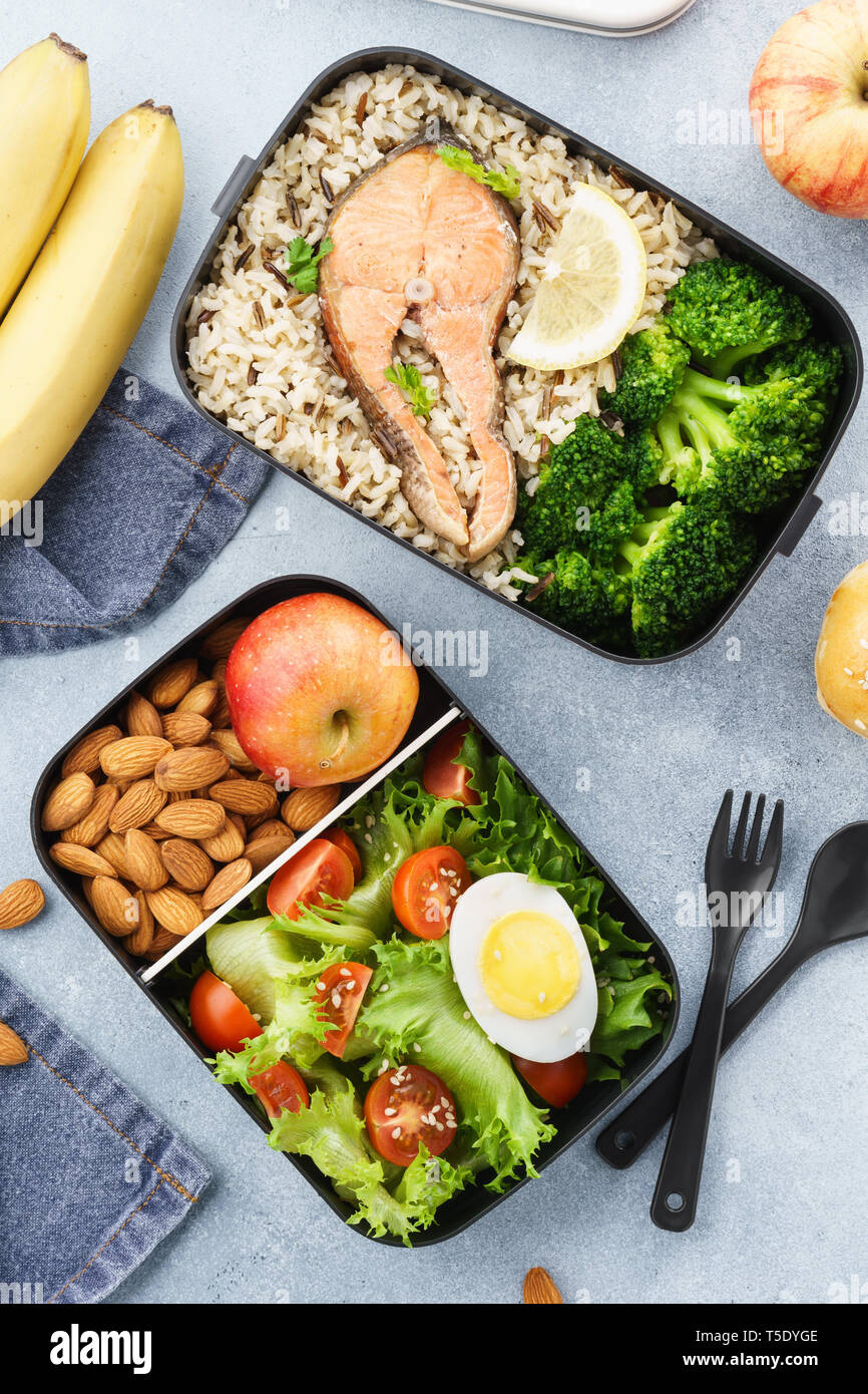 Lunch boxes with food ready to go for work or school. Meal preparation or dieting concept. Stock Photo